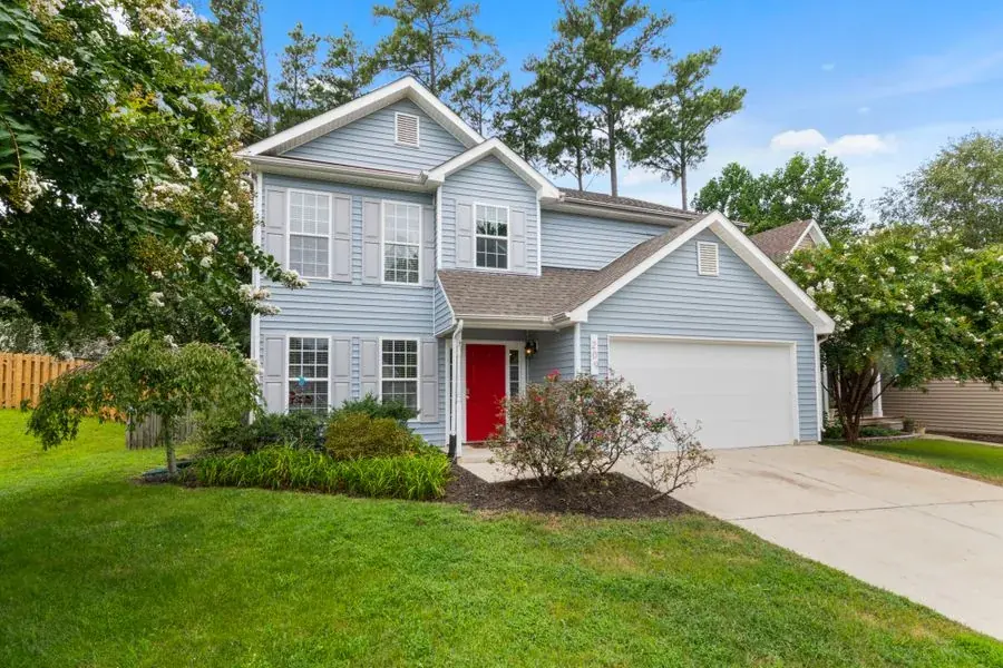 Two story home with a front lawn
